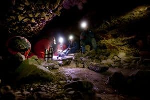 A group of people eating lunch in the Kuna Caves